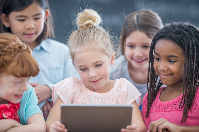 Kids looking at laptop